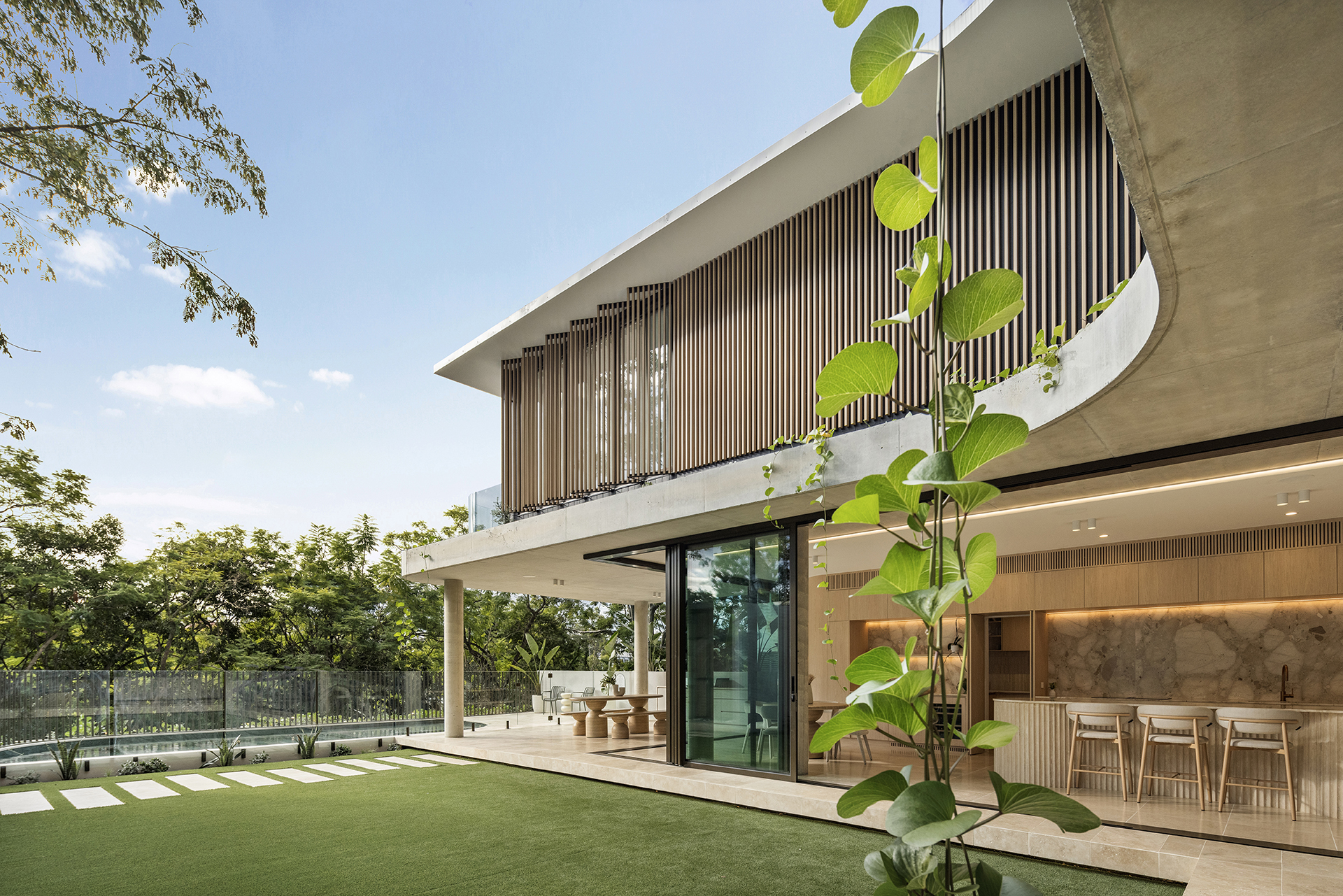 Poolside view through the sculptural architecture