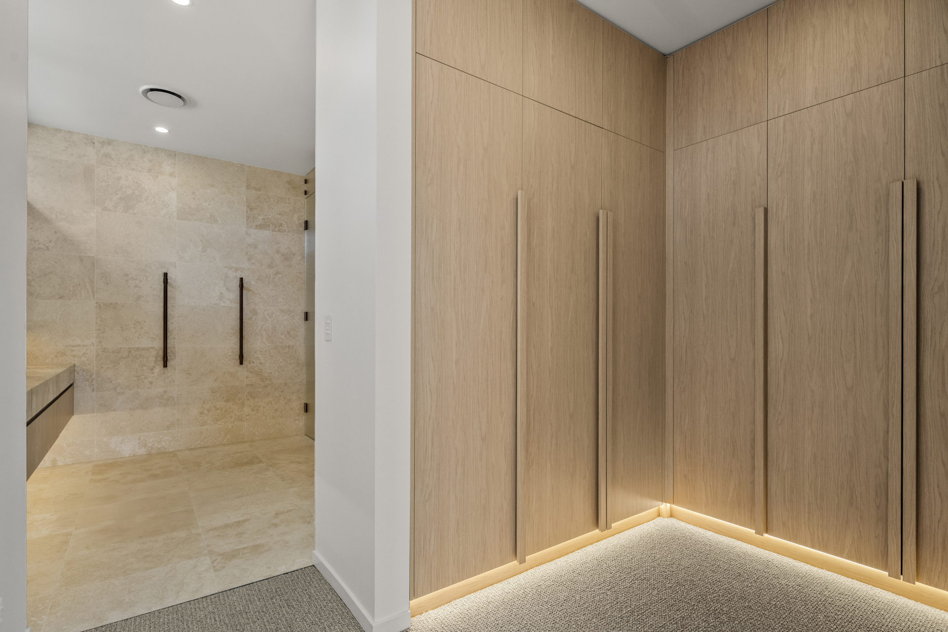 Timber dressing room and stone ensuite transition