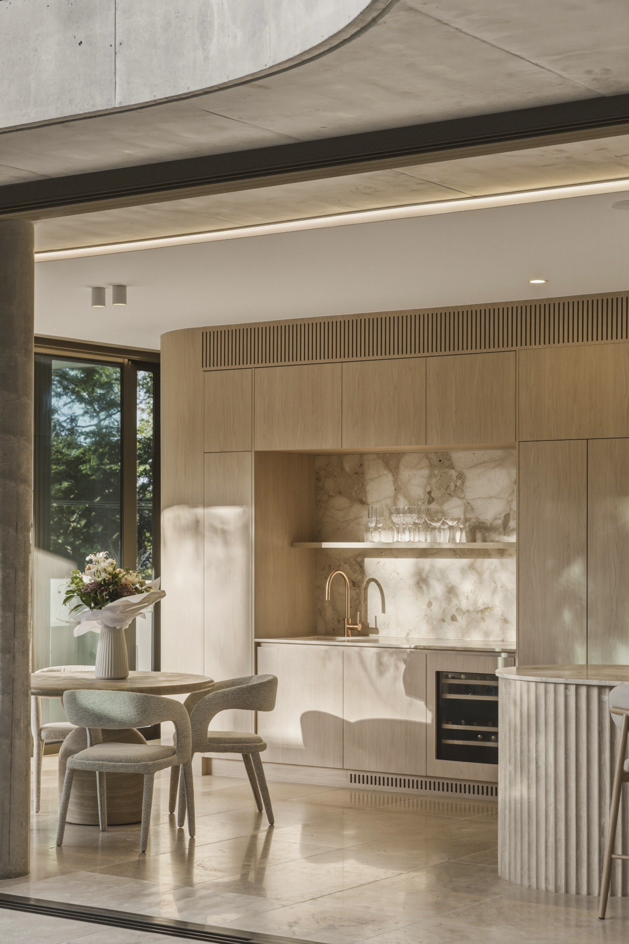 Fluted travertine kitchen and layered stone finishes