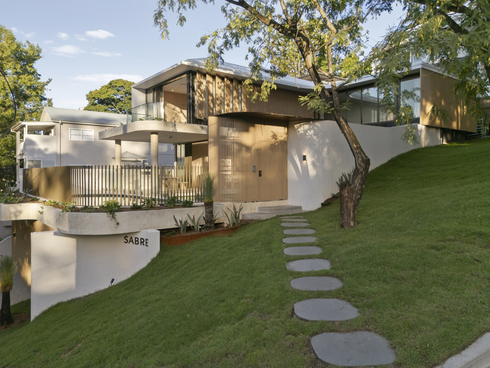 The house opening completely to the courtyard lawn